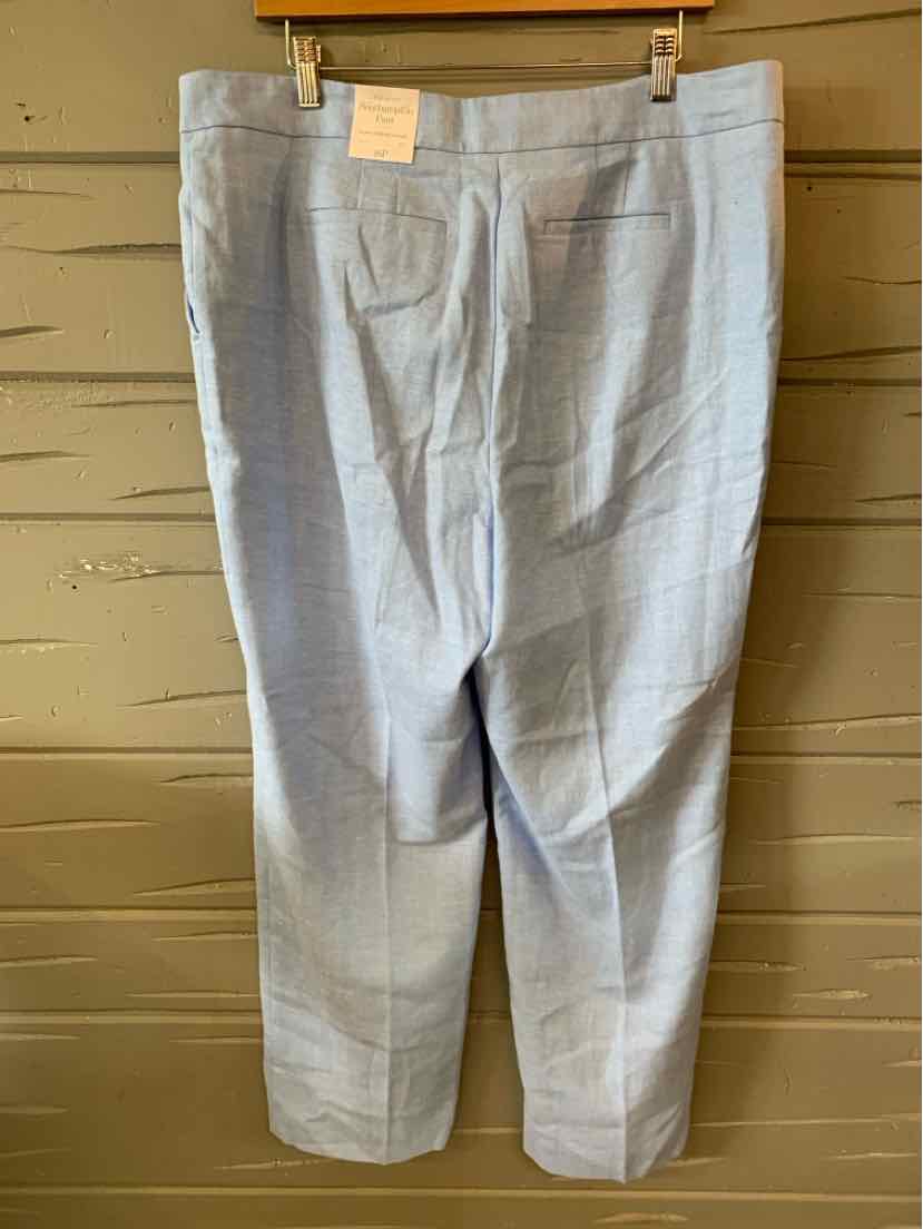 Light blue tailored women's pants with a straight cut and front zipper closure hanging on a wooden hanger.