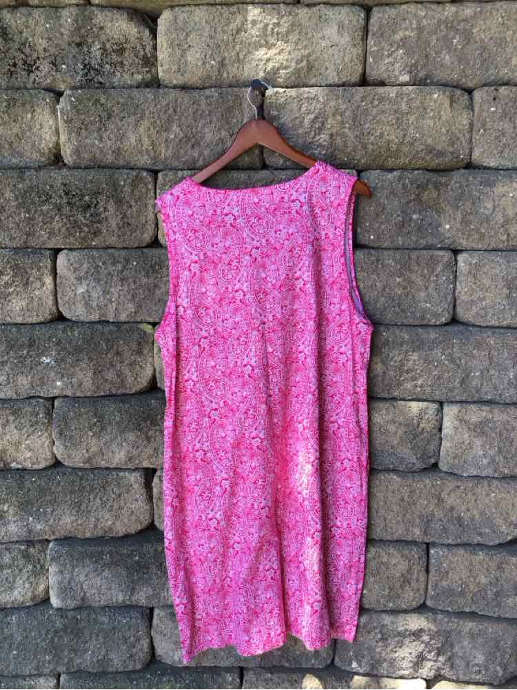 Pink sleeveless dress with paisley pattern, loose fit, and knee-length hem.