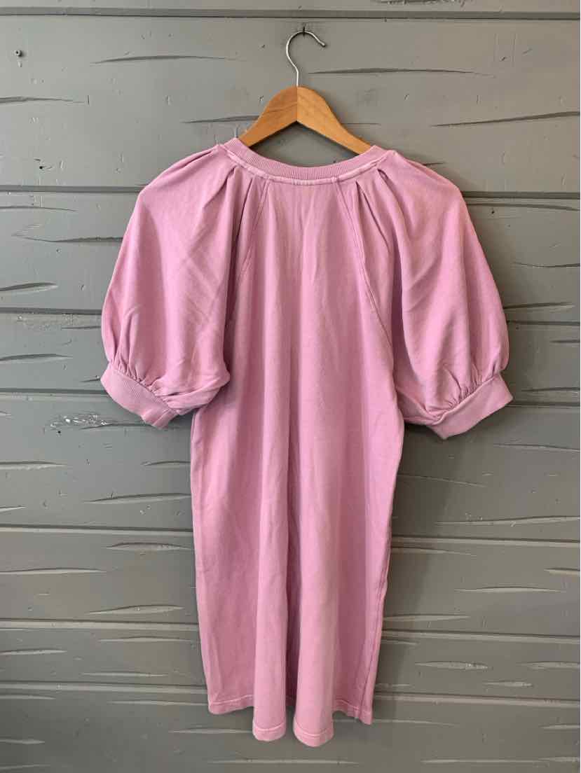 Light pink knee-length dress with puffed short sleeves and a round neckline hanging on a wooden hanger.