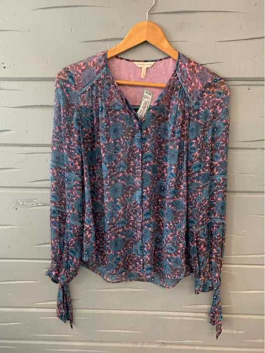 Blue floral long-sleeve blouse with button front and tie cuffs, size 4, hanging on wooden hanger.