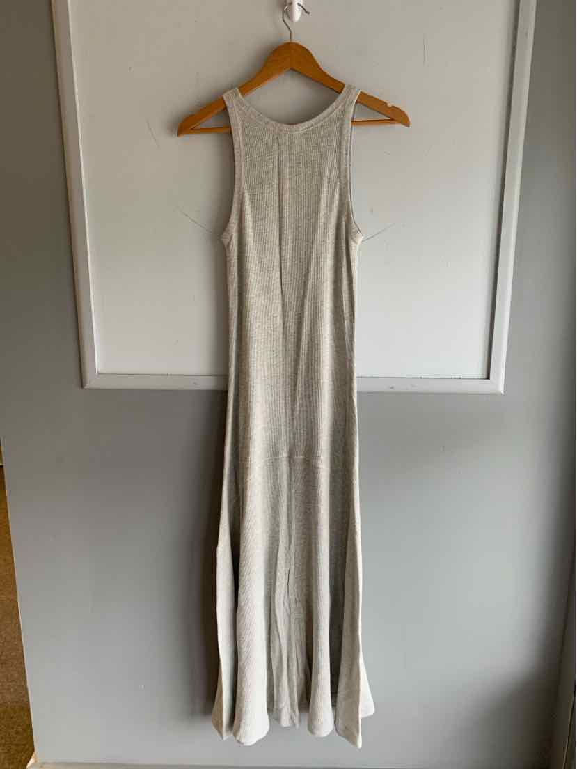 Light gray sleeveless maxi dress with a ribbed texture and a fitted bodice hanging on a wooden hanger.