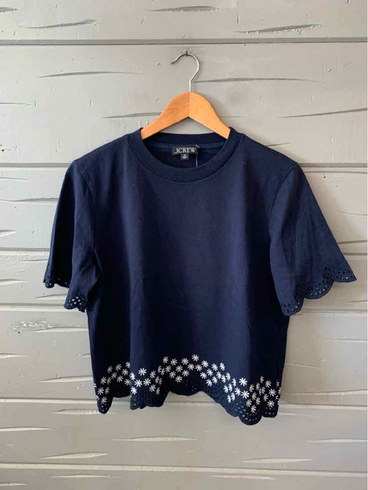 Navy blue crewneck short-sleeve t-shirt with white scalloped dot pattern along the hem.