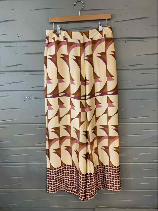 Beige and brown patterned wide-leg pants with geometric designs and a checkered hem, size 6.