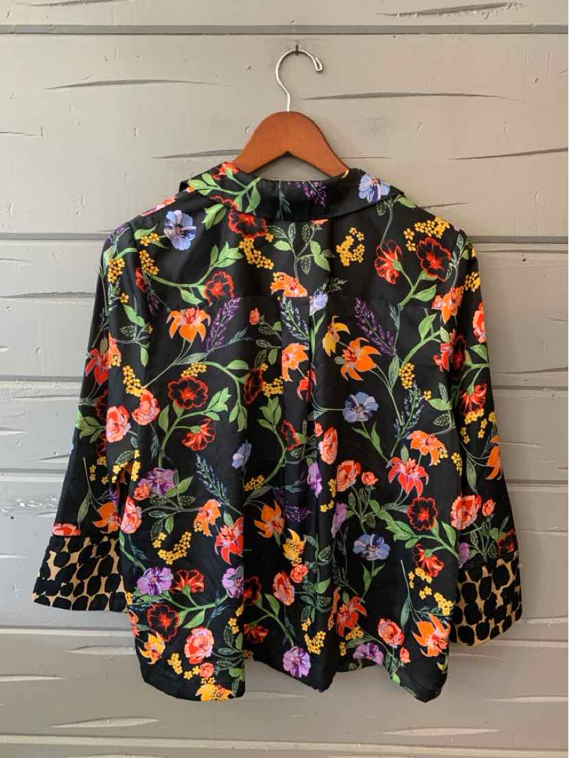 Black floral blouse with vivid multicolor flowers, long sleeves, button front, and ruffled collar.
