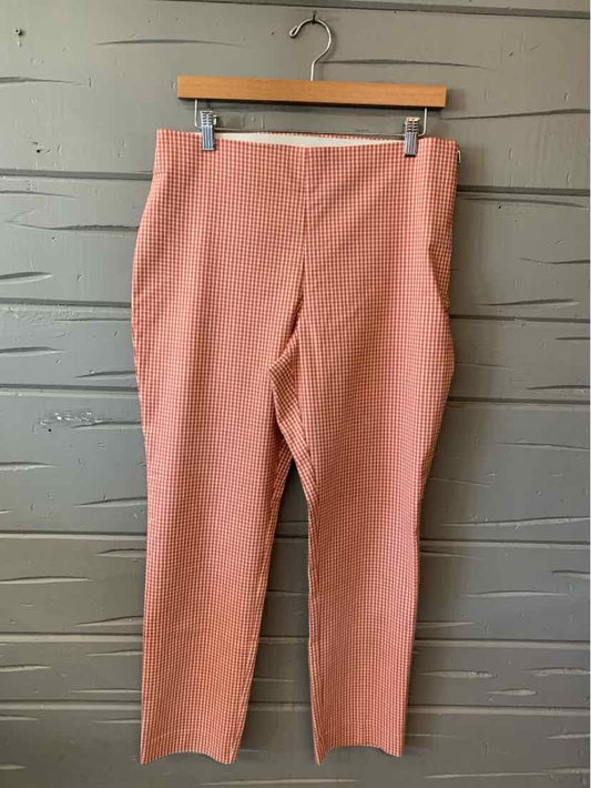 Rust-colored slim-fit pants in size 12 with a smooth, slightly textured fabric and a straight leg cut.