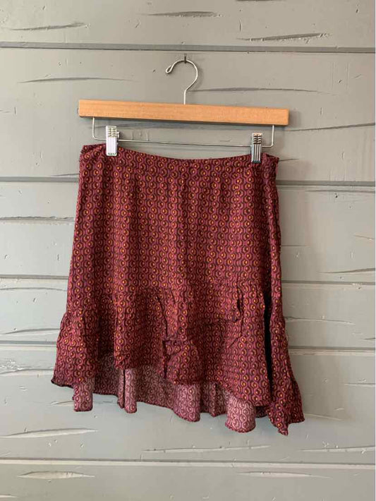Burgundy textured mini skirt with ruffled hem and subtle check pattern.