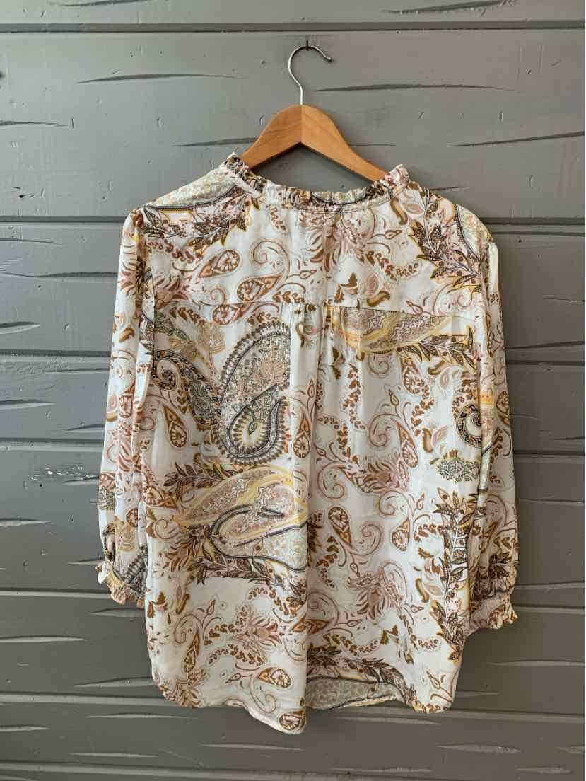 Long-sleeve blouse in white with brown and beige paisley pattern, featuring a round neckline and a chest pocket.