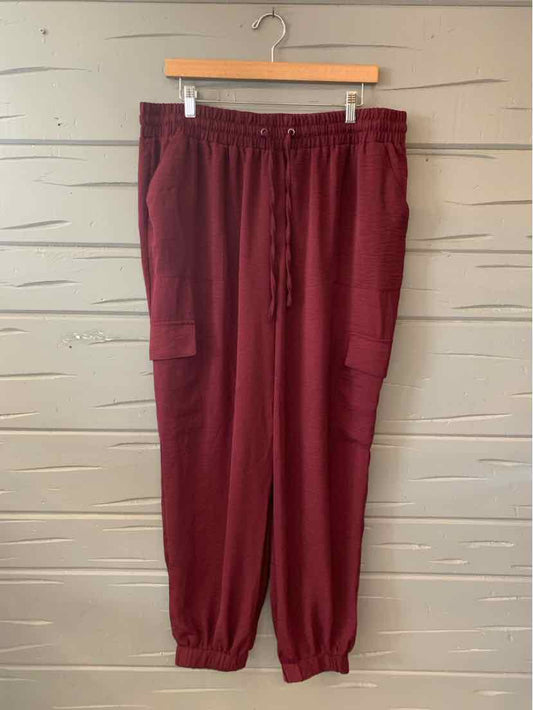 Burgundy jogger pants with elastic waistband, drawstring, side pockets, and cuffed ankles in size XL.