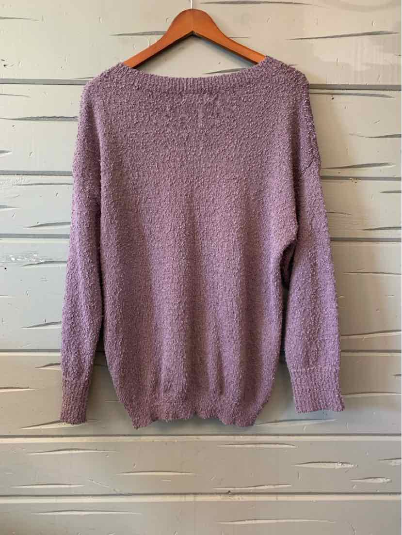 Mauve women's casual top with long sleeves and textured fabric hanging on wooden hanger.