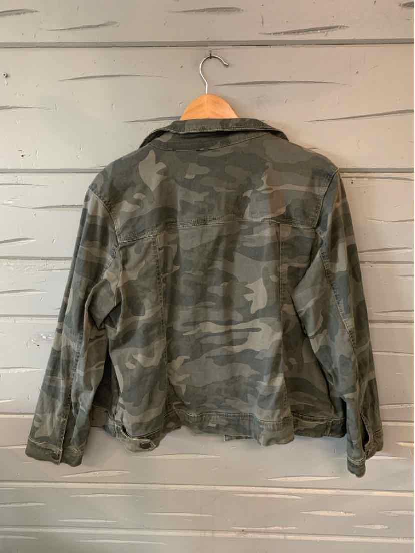 Green and gray camo-print long-sleeve denim jacket with a relaxed fit on wooden hanger.