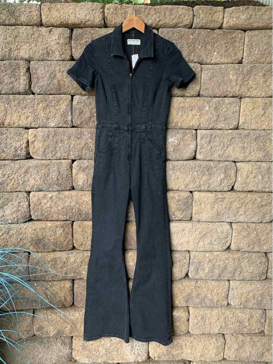 Black denim jumpsuit with short sleeves, collar, front zipper, and flared legs in size small.
