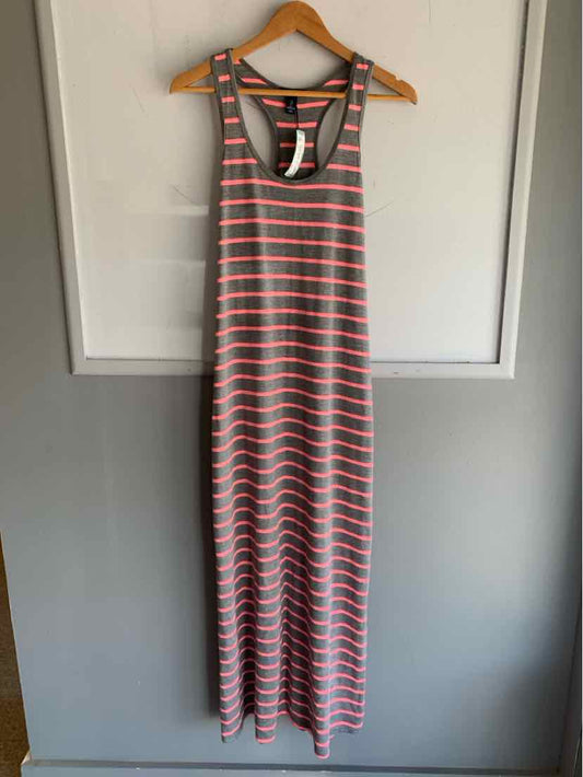 Gray and light coral striped sleeveless maxi dress with racerback hanging on wooden hanger.