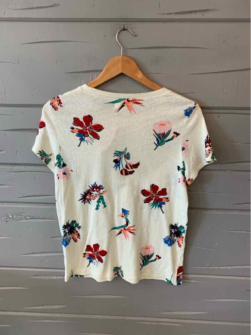 White short-sleeve shirt with colorful floral print in red, pink, and green, medium size.