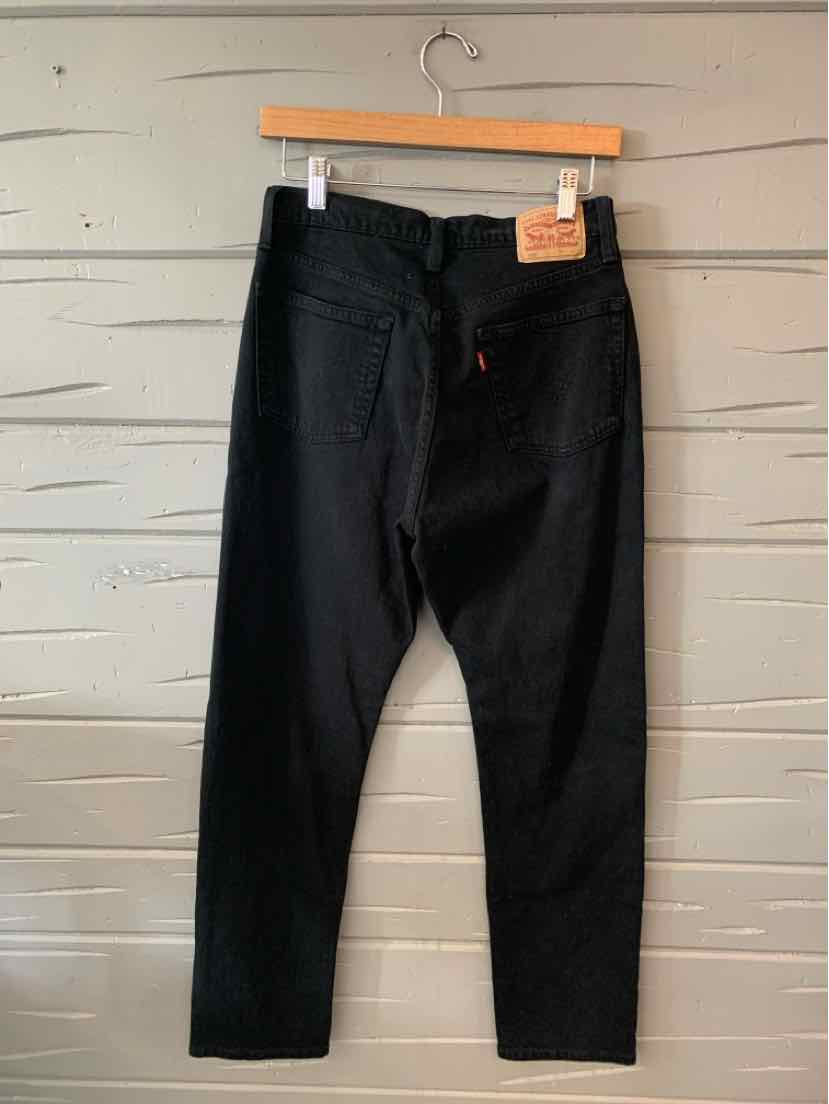 Black Levi's denim jeans in size 4 with classic five-pocket design and leather logo patch on waistband.