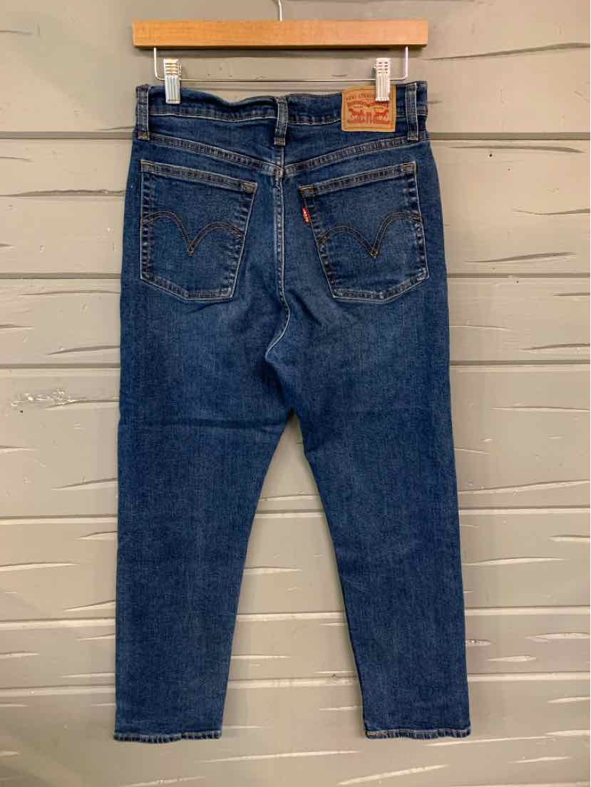 Dark blue Levi's denim jeans with straight legs, visible back pockets, and leather brand patch on waistband.