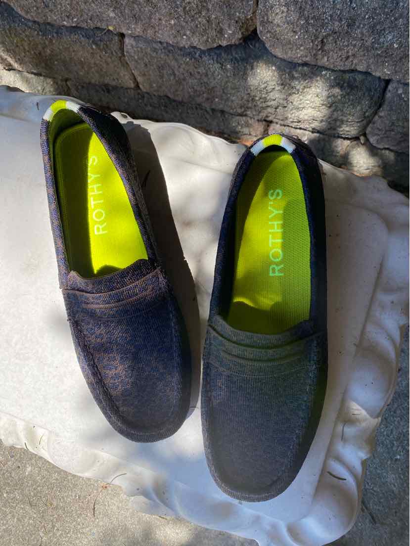 Pair of Rothy’s slip-on shoes in size 10.5 with textured fabric upper, one in dark blue and the other in dark gray, both.