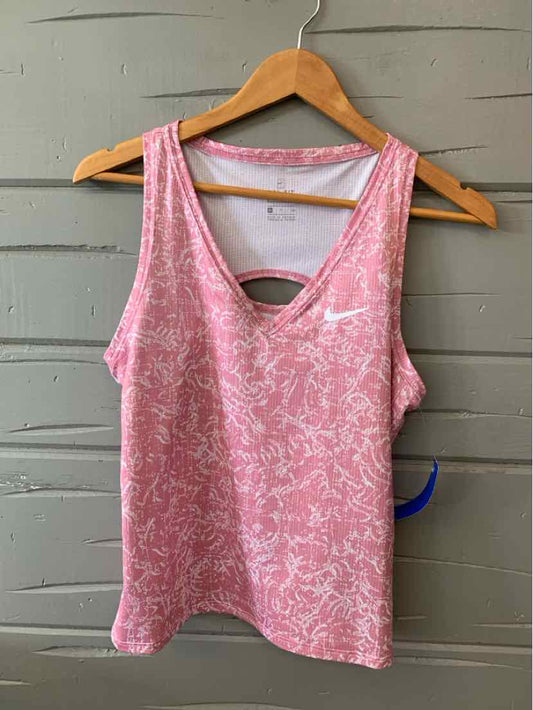Pink and white patterned Nike tank top with white swoosh logo on chest, racerback style.