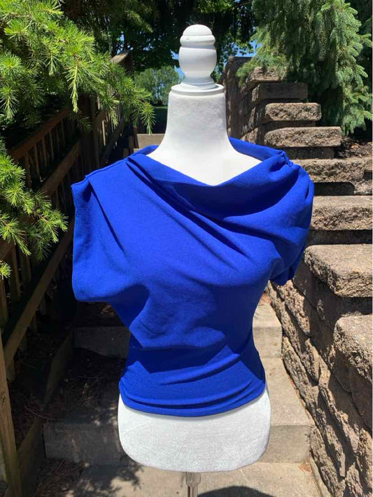 Bright blue asymmetrical off-shoulder top with draped neckline and fitted waist on mannequin.