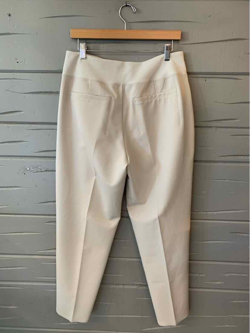 Beige tapered pants with back pockets and a fitted waistband, size 10, hanging on wooden hanger.