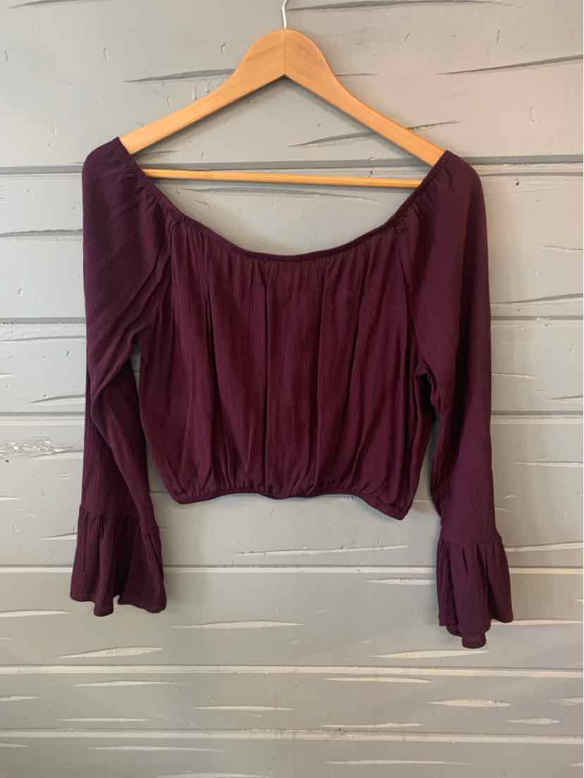 Long-sleeve plum purple cropped blouse with flared cuffs and gathered neckline.