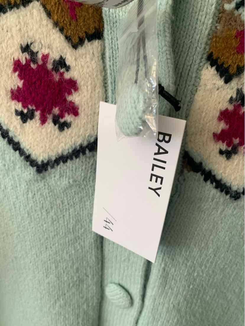 Light blue knit sweater with white and burgundy geometric patterns and a Bailey tag attached.