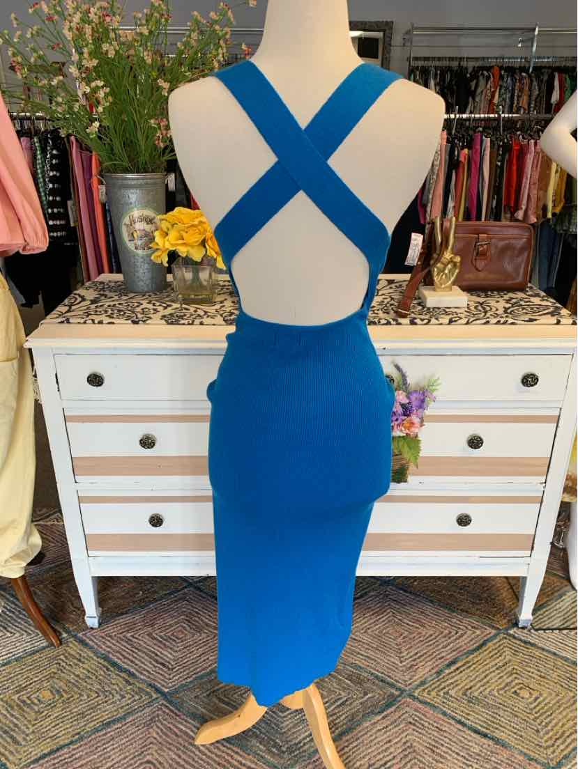Royal blue sleeveless midi dress with crisscross back straps and fitted silhouette.