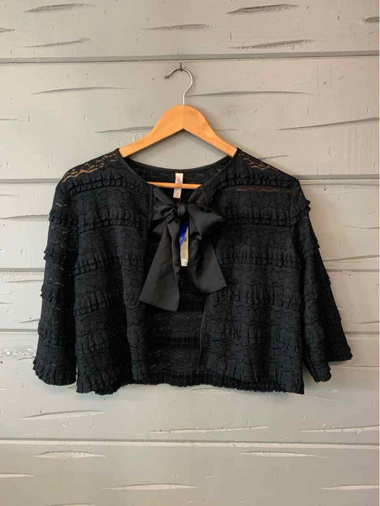 Black lace Lyrebird blouse with a sheer scalloped yoke, flared sleeves, and a necktie bow.