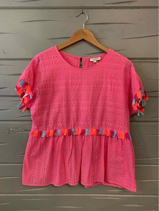 Pink eyelet short-sleeve blouse with multicolor ruffle trim on sleeves and waist, size large.