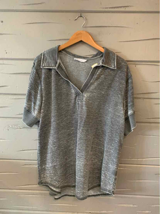 Gray short-sleeve polo shirt with collar and button placket, hanging on wooden hanger.