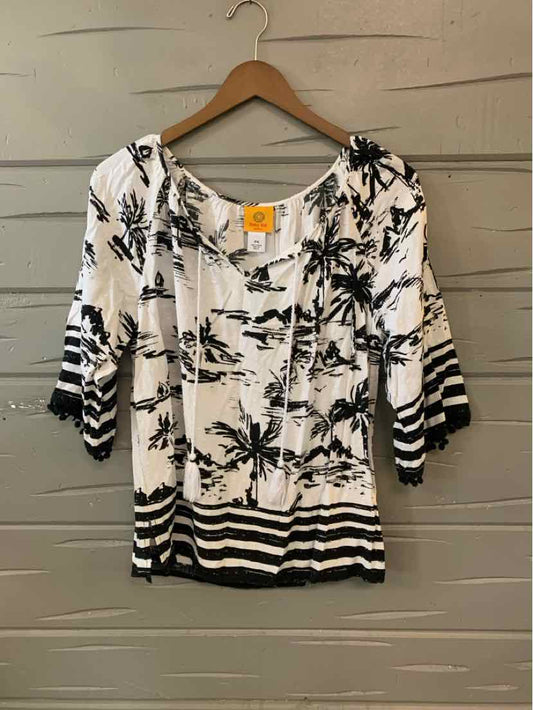 White blouse with black tropical floral print and black striped hem and sleeves, medium size.