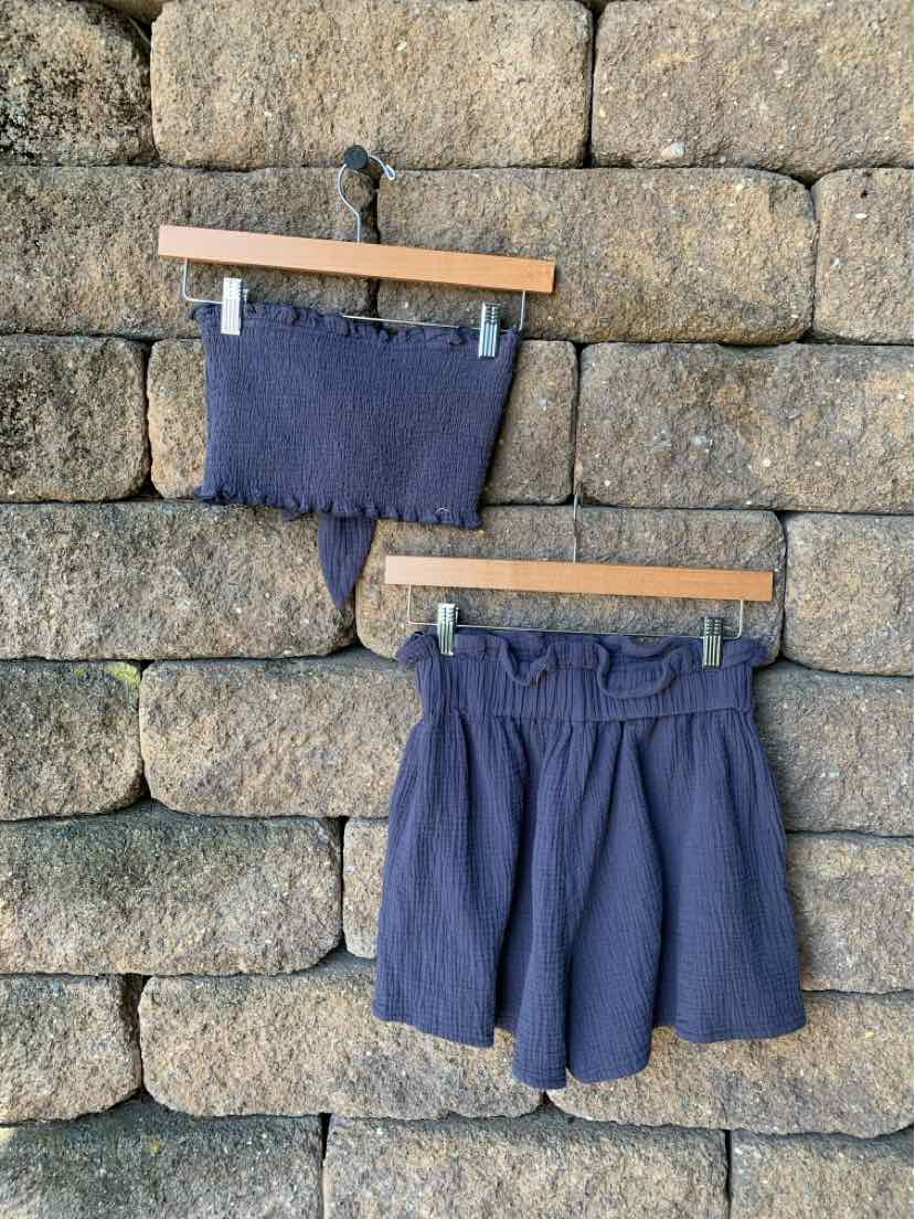 Navy blue two-piece set with a strapless, ribbed crop top and high-waisted, relaxed shorts with an elastic waistband.