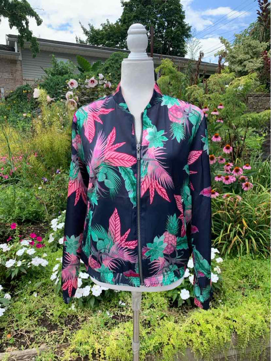 Navy zip-up jacket with vibrant pink and green tropical leaf print, long sleeves, and a fitted silhouette.