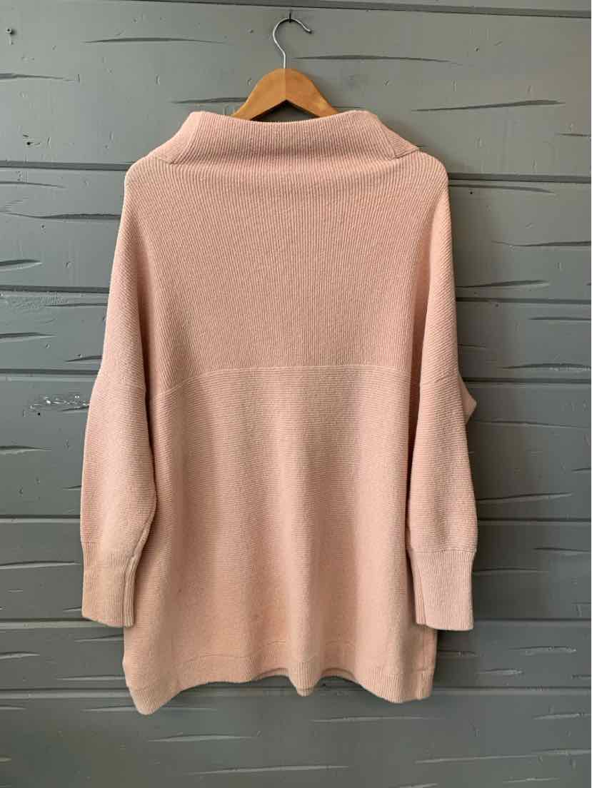 Soft pale pink knit cardigan with a draped open front and relaxed fit in medium size.