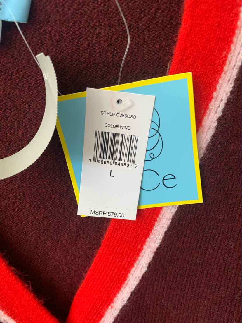 Burgundy knit fabric with pink and white stripes and attached blue and white clothing tags.