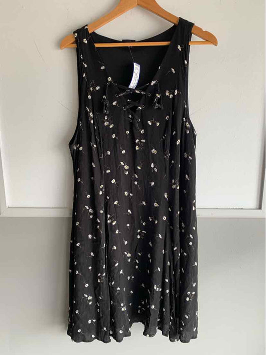Black sleeveless dress with small white floral print and scoop neckline, size 1X.
