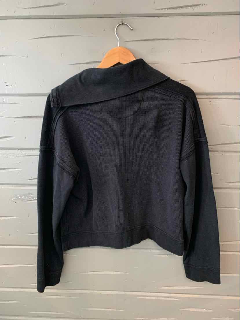 Black long-sleeve lightweight jacket with a wide collar and relaxed fit hanging on wooden hanger.