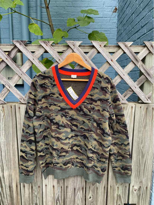 Women's V-neck camo sweater with orange trim and ribbed cuffs and hem on wooden hanger.