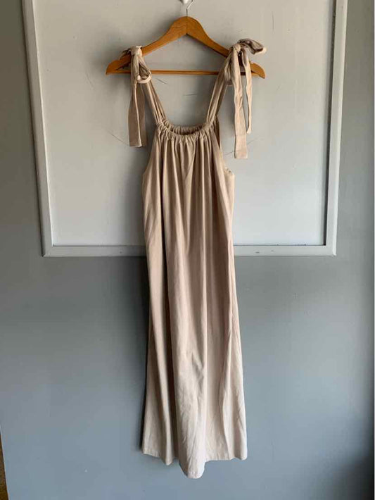 Beige sleeveless dress with gathered bodice and adjustable tie straps, flowy fabric, size small.