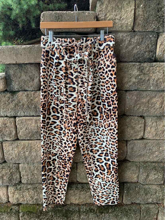 Tan and brown cheetah print jogger pants with elastic waistband and drawstring, tapered legs.