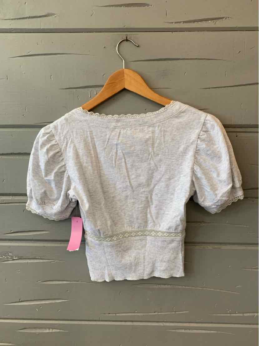 Light gray short-sleeve blouse with puffed sleeves and fitted waist on wooden hanger.