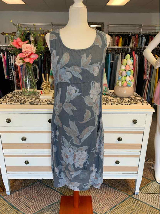 Sleeveless navy blue floral midi dress with light blue and gray flowers on mannequin.