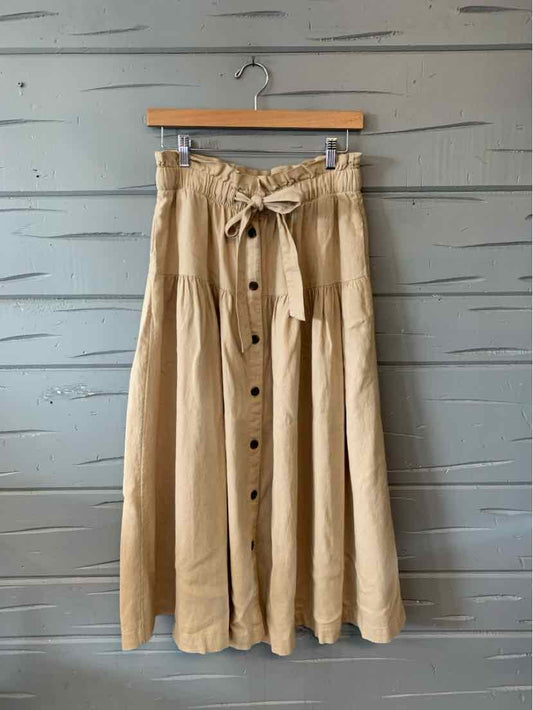 Khaki button-front midi skirt with gathered waist and fabric belt tie in lightweight material.