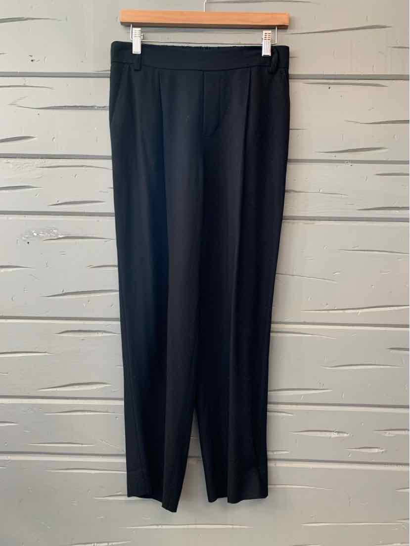 Black women’s Vince trousers with a straight, relaxed leg, hanging from a wooden clip hanger.