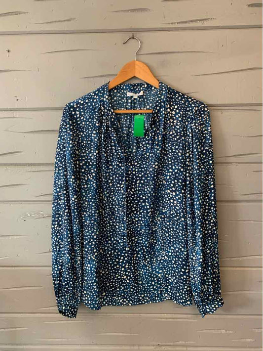 Blue blouse with white abstract dot pattern, long sleeves, and collar, size XL.