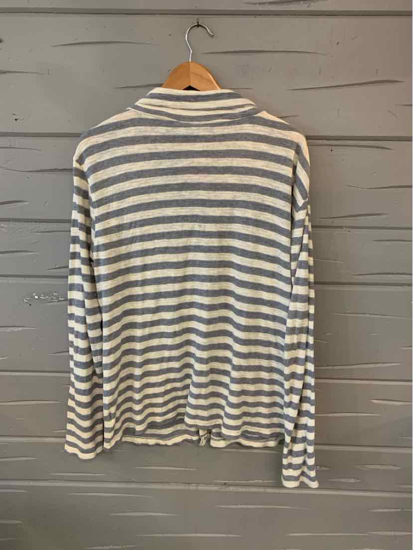 Long-sleeve striped shirt in blue and white with a relaxed fit hanging on wooden hanger.