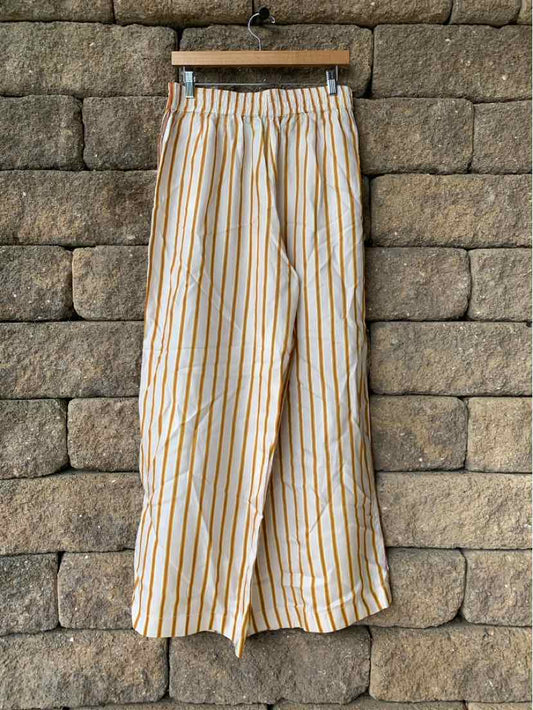 Light beige wide-leg pants with vertical pink and orange stripes, elastic waistband, lightweight fabric.