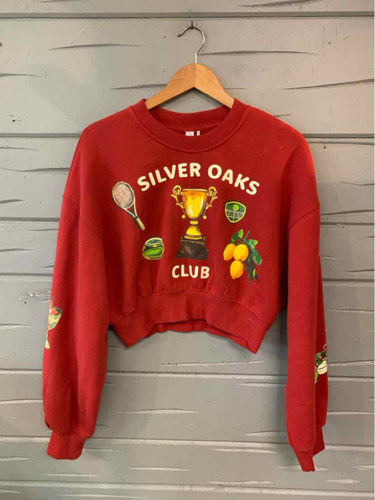 Red cropped long-sleeve sweatshirt with a Silver Oaks Club graphic, tennis racket, trophy, and fruit motifs.