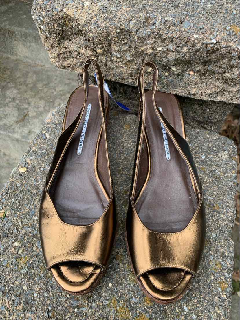 Brown metallic peep-toe slingback flats with low heels and cushioned insoles.
