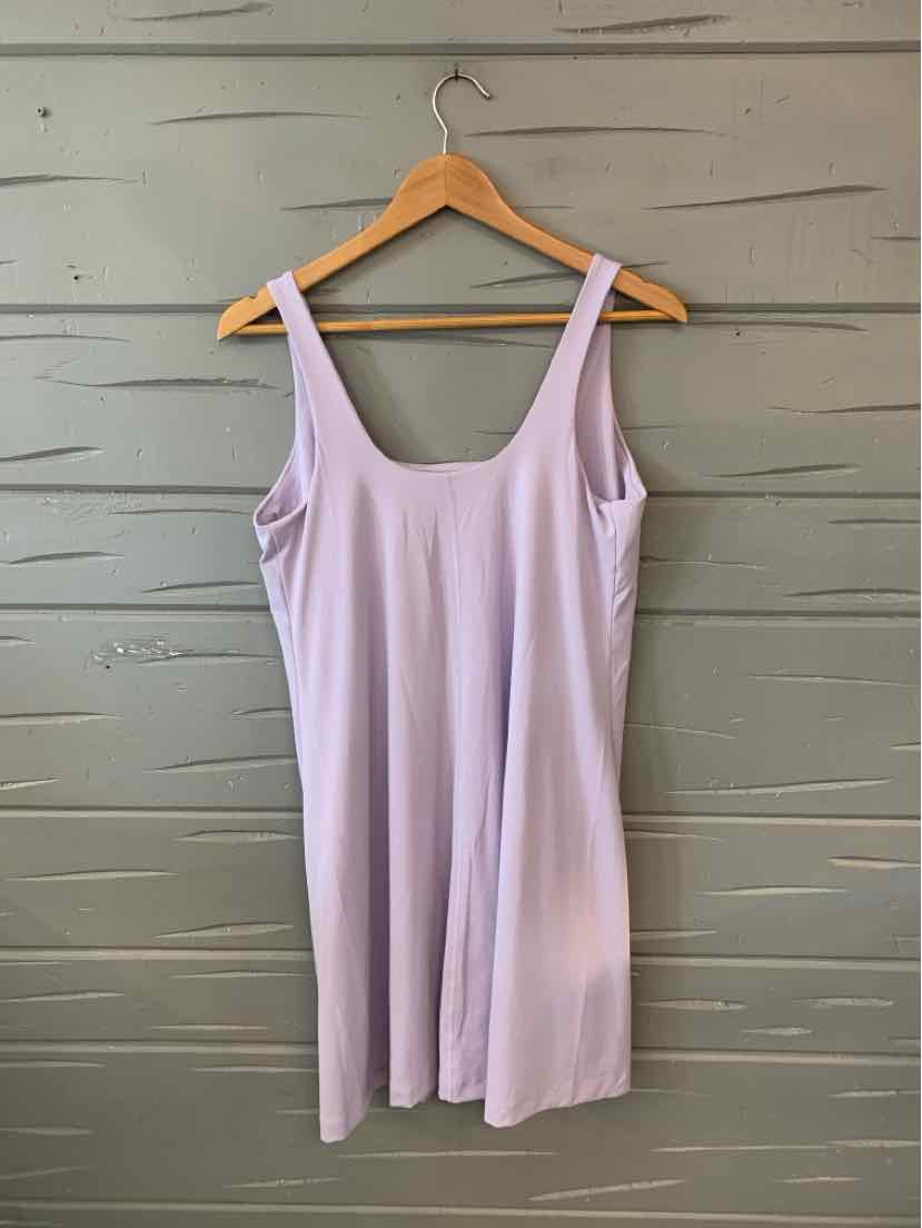 Light purple sleeveless dress with scoop neckline and straight silhouette hanging on wooden hanger.