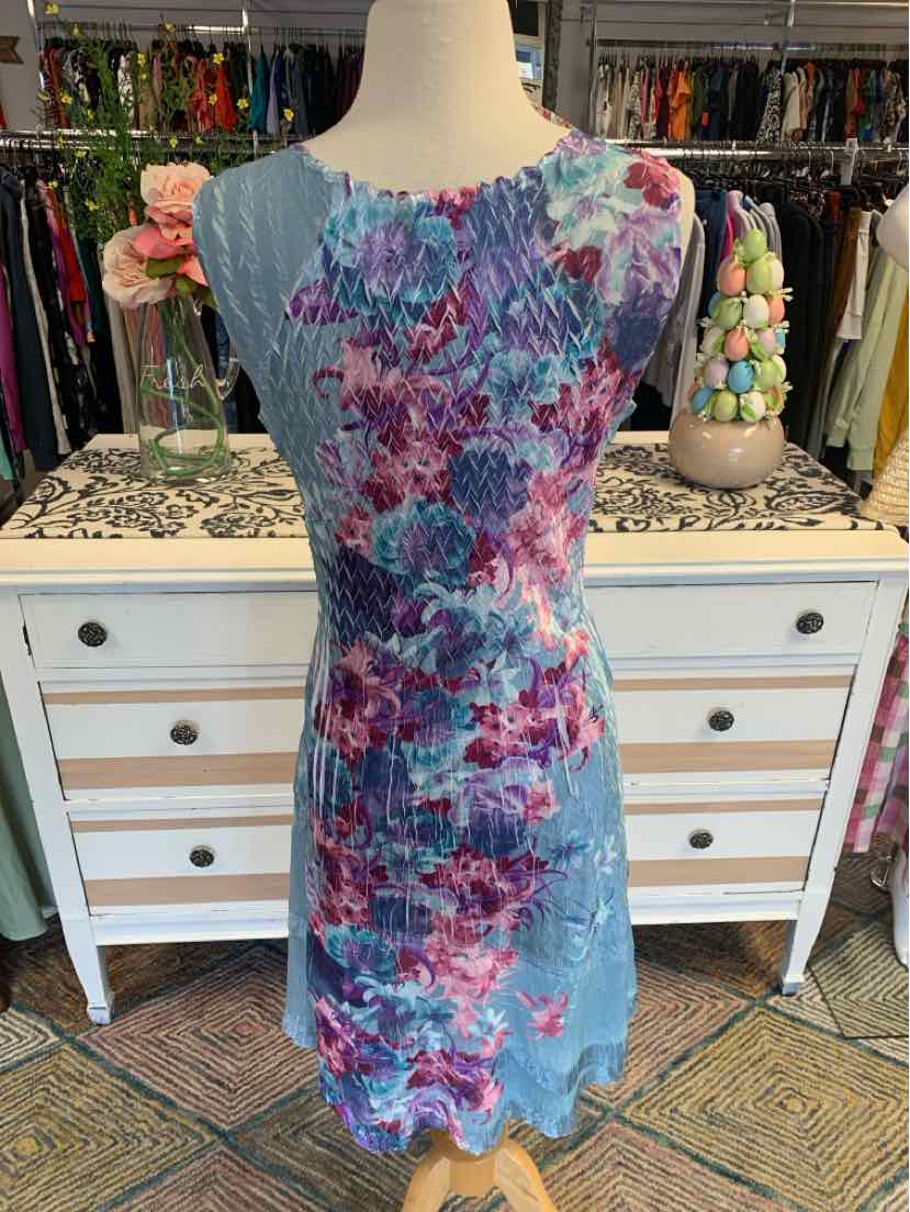 Light blue floral lace dress with purple and pink flower patterns, sleeveless with scalloped edges.